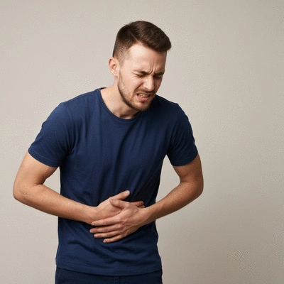 Person holding their stomach in discomfort, representing acid reflux
